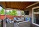 Inviting covered patio with a wood ceiling, comfy seating, and outdoor entertainment, perfect for relaxation at 10397 Helsinki St, Parker, CO 80134