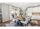 Bright dining area features backyard views, modern chandelier, and an open layout at 10397 Helsinki St, Parker, CO 80134