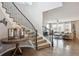 View of the home foyer and hardwood floors, with a staircase and an open living space at 10397 Helsinki St, Parker, CO 80134