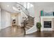 Elegant foyer features hardwood floors, staircase, fireplace, and open layout at 10397 Helsinki St, Parker, CO 80134