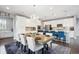 A spacious kitchen and dining area is illuminated by a chandelier and natural light at 10397 Helsinki St, Parker, CO 80134