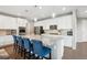 Open kitchen showcases an island with seating, granite countertops, and modern lighting at 10397 Helsinki St, Parker, CO 80134