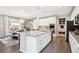 Bright kitchen boasts a spacious island, stainless appliances, and opens to the dining area at 10397 Helsinki St, Parker, CO 80134