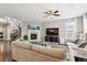 Bright living room featuring a fireplace, staircase, and comfortable seating area at 10397 Helsinki St, Parker, CO 80134