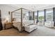 Bright main bedroom with a four-poster bed, ample natural light, and chic decor for a peaceful retreat at 10397 Helsinki St, Parker, CO 80134