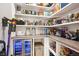 Walk-in pantry with organized shelves, storage baskets, and a wine refrigerator at 10397 Helsinki St, Parker, CO 80134