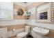 A stylish powder room with striped walls, a floating sink, and a decorative mirror at 10397 Helsinki St, Parker, CO 80134