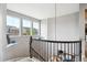Elegant staircase with wrought iron railing and decorative pendant lighting, offering a stylish transition at 10397 Helsinki St, Parker, CO 80134