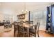 Dining area with hardwood floors, a wooden table, and view into the living room at 10491 Tiger Run, Lone Tree, CO 80124