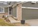 Front entrance with a walkway leading to a red door and an attached garage at 10491 Tiger Run, Lone Tree, CO 80124