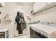 Laundry room with washer, dryer, and storage shelves at 10491 Tiger Run, Lone Tree, CO 80124