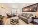 Living room with hardwood floors, gray couch, and large framed art piece at 10491 Tiger Run, Lone Tree, CO 80124