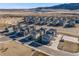 Aerial view of modern townhome community in a scenic landscape near a lake at 15624 W Floyd Dr, Morrison, CO 80465