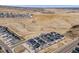 Aerial view of townhome community surrounded by open land and distant city skyline at 15624 W Floyd Dr, Morrison, CO 80465