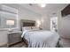 Cozy bedroom with tufted headboard, neutral palette, and view to the outside at 15624 W Floyd Dr, Morrison, CO 80465