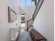 Bright foyer features high ceilings, a console table, a tufted bench, and staircase at 15624 W Floyd Dr, Morrison, CO 80465