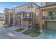 Exterior view of townhome featuring stone accents, covered porch, and attached garage at 15624 W Floyd Dr, Morrison, CO 80465