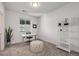 Bright home office with white walls, carpet, natural light, a modern desk, and decorative shelving at 15624 W Floyd Dr, Morrison, CO 80465