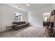 Cozy bonus living area with a comfortable sofa, a large window, carpet, and a view into the bathroom at 15624 W Floyd Dr, Morrison, CO 80465