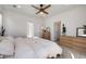 Bright bedroom featuring a ceiling fan, soft carpet, and two dressers providing ample storage space at 15624 W Floyd Dr, Morrison, CO 80465