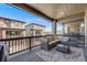 Relaxing outdoor patio features comfortable seating with views of neighboring homes and a stylish leaf-patterned rug at 15624 W Floyd Dr, Morrison, CO 80465