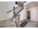 Carpeted staircase with metal railing and wood banister leads to the upper level of the house at 15624 W Floyd Dr, Morrison, CO 80465