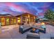 Back patio features outdoor seating, a fire pit, and seamless access to indoor living areas at 5727 Colorow Dr, Morrison, CO 80465