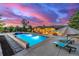 The backyard includes a swimming pool, hot tub, fire pit, and lounge chairs for ultimate relaxation at 5727 Colorow Dr, Morrison, CO 80465