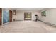 Spacious basement area with carpet and exercise equipment, plus large doors to outdoor space at 5727 Colorow Dr, Morrison, CO 80465
