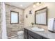Traditional bathroom features tiled walls, a framed mirror, vanity with updated countertop, and white fixtures at 5727 Colorow Dr, Morrison, CO 80465