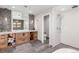 Modern bathroom features stone accent wall, wood cabinets, and a glass-enclosed shower, plus updated vanity with sleek countertop at 5727 Colorow Dr, Morrison, CO 80465