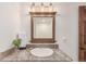 Functional bathroom with an updated vanity, framed mirror, granite countertop, and neutral walls at 5727 Colorow Dr, Morrison, CO 80465