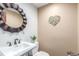 Charming half-bath with decorative mirror and floral decor at 5727 Colorow Dr, Morrison, CO 80465