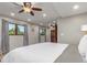 Bright bedroom features windows, a ceiling fan, plush carpet, and neutral paint, plus views to outdoor area at 5727 Colorow Dr, Morrison, CO 80465