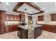 Gourmet kitchen with stainless steel appliances, custom cabinets, granite countertops, and a large island at 5727 Colorow Dr, Morrison, CO 80465