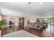 Open living room with hardwood floors, large windows to backyard and pool at 5727 Colorow Dr, Morrison, CO 80465