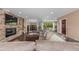 Large living room features a stone fireplace and large windows to the backyard at 5727 Colorow Dr, Morrison, CO 80465
