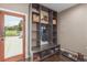 Mudroom with a built-in storage bench and coat rack by the entrance at 5727 Colorow Dr, Morrison, CO 80465