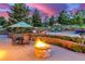The pool area features a fire pit, lounge chairs, and lush landscaping for relaxation at 5727 Colorow Dr, Morrison, CO 80465