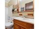 Classic bathroom with a wood vanity, tiled shower, and traditional fixtures at 30651 Hollings Way, Golden, CO 80403