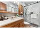 Modern bathroom boasts a marble shower with glass doors and a stylish wood vanity at 30651 Hollings Way, Golden, CO 80403