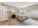 Well-lit bedroom with two windows, neutral paint, and a comfortable bed at 30651 Hollings Way, Golden, CO 80403