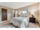 Cozy bedroom features plush carpeting, a comfortable bed, and bedside tables with lamps at 30651 Hollings Way, Golden, CO 80403