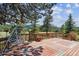 Large wooden deck with a swing and picturesque views of trees and mountains at 30651 Hollings Way, Golden, CO 80403