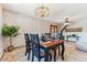 Formal dining room featuring a stylish chandelier, table set for four, and decorative wall coverings at 30651 Hollings Way, Golden, CO 80403