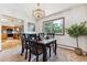 Cozy dining room features a chandelier, a picture window with nature views, and an open floor plan at 30651 Hollings Way, Golden, CO 80403