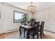 Dining room features a chandelier, a picture window with mountain views, and carpeted floors at 30651 Hollings Way, Golden, CO 80403