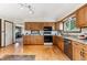 Bright kitchen features hardwood floors, granite countertops, updated appliances, and ample storage at 30651 Hollings Way, Golden, CO 80403