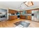 Open kitchen features hardwood floors, stainless steel appliances, granite countertops, and a skylight at 30651 Hollings Way, Golden, CO 80403