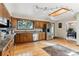 Bright kitchen with hardwood floors, stainless steel appliances, granite counters, and unique ceiling detail at 30651 Hollings Way, Golden, CO 80403